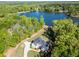Aerial view of the home nestled on a wooded lot with lake views in the distance at 45 Kinloch Ct, Covington, GA 30014