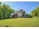 Spacious backyard with multi-level wooden deck perfect for outdoor entertaining and scenic views at 45 Kinloch Ct, Covington, GA 30014