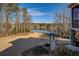 Scenic backyard with a view of the lake, mature trees, and well-maintained lawn at 45 Kinloch Ct, Covington, GA 30014