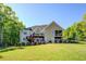 Green backyard with tiered deck overlooking lake and woods at 45 Kinloch Ct, Covington, GA 30014