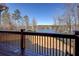 Back porch with wooden railing and a nice view of the lake and lawn at 45 Kinloch Ct, Covington, GA 30014