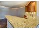 Wet bar with granite counter top and hardwood cabinets at 45 Kinloch Ct, Covington, GA 30014