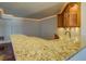 View of the granite bar top and wood cabinetry with under cabinet lighting at 45 Kinloch Ct, Covington, GA 30014