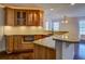 View of the wet bar featuring granite countertops, tiled backsplash, wooden cabinets, and recessed lighting at 45 Kinloch Ct, Covington, GA 30014