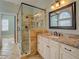 Modern bathroom with a glass-enclosed shower, stone countertops, and tiled flooring at 45 Kinloch Ct, Covington, GA 30014