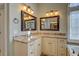 Bathroom vanity with granite countertop, dual mirrors, and attractive lighting fixtures at 45 Kinloch Ct, Covington, GA 30014