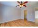 Bedroom with hardwood floors, ceiling fan with lights, and an open closet at 45 Kinloch Ct, Covington, GA 30014