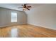 Bright bedroom featuring hardwood floors, ceiling fan, and ample space at 45 Kinloch Ct, Covington, GA 30014