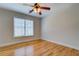 Bedroom with wooden floors, ceiling fan and light, and window with white blinds at 45 Kinloch Ct, Covington, GA 30014