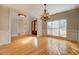 Bright dining room with hardwood floors, large windows, and elegant lighting fixtures at 45 Kinloch Ct, Covington, GA 30014