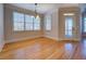 Sunlit dining room with large windows, hardwood floors, and access to a porch at 45 Kinloch Ct, Covington, GA 30014