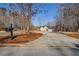 Long driveway leading to lovely home with mature landscaping on a sunny day at 45 Kinloch Ct, Covington, GA 30014