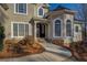 Elegant front entrance with stone accents, arched windows, and a welcoming walkway at 45 Kinloch Ct, Covington, GA 30014