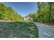 Expansive home with a long driveway, set amongst lush greenery and blue skies at 45 Kinloch Ct, Covington, GA 30014