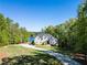 Stunning two-story home with a long driveway, lush landscaping, and lake view at 45 Kinloch Ct, Covington, GA 30014