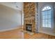 Stone fireplace with gas logs, hardwood floors and arched windows at 45 Kinloch Ct, Covington, GA 30014
