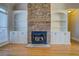 Close up view of the fireplace featuring stone surround and built-in shelving at 45 Kinloch Ct, Covington, GA 30014