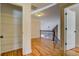 Upstairs hallway with hardwood floors, coat closet, and stairway with wood and metal banister at 45 Kinloch Ct, Covington, GA 30014