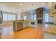 Beautiful kitchen featuring an island, fireplace, granite countertops and stainless appliances at 45 Kinloch Ct, Covington, GA 30014