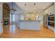 Gourmet kitchen features a stone fireplace, island, and stainless steel appliances at 45 Kinloch Ct, Covington, GA 30014