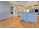 Open kitchen with granite countertops, island, and hardwood flooring at 45 Kinloch Ct, Covington, GA 30014