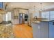 Island kitchen with stone countertops, stainless appliances, and abundant storage at 45 Kinloch Ct, Covington, GA 30014