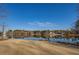 Picturesque view of the lake reflecting the surrounding trees and homes under a clear, blue sky at 45 Kinloch Ct, Covington, GA 30014