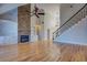 Open living room with hardwood floors, stone fireplace, and built-in shelving at 45 Kinloch Ct, Covington, GA 30014