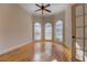 Sun-filled living room featuring hardwood floors and large arched windows at 45 Kinloch Ct, Covington, GA 30014