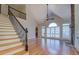 Open living room with fireplace, hardwood floors, vaulted ceiling, and staircase at 45 Kinloch Ct, Covington, GA 30014