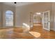 Sun-drenched living room with hardwood floors and glass french doors to another room at 45 Kinloch Ct, Covington, GA 30014