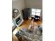 Cozy living room with a fireplace, hardwood floors, comfortable seating, and natural light at 8535 Lynn Dr, Cumming, GA 30041