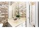 Bathroom with brick feature wall and a single sink vanity at 1114 Ivey Chase Pl, Dacula, GA 30019