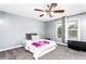 Bright bedroom featuring a comfy bed, ceiling fan, and ample natural light at 1114 Ivey Chase Pl, Dacula, GA 30019