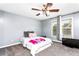 Bedroom featuring a bed, two windows, gray walls and a ceiling fan at 1114 Ivey Chase Pl, Dacula, GA 30019