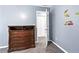 Bedroom with dresser and access to another room at 1114 Ivey Chase Pl, Dacula, GA 30019