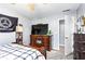 Bedroom featuring a wooden dresser with a large television and a view into the hallway at 1114 Ivey Chase Pl, Dacula, GA 30019