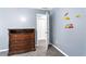 Bedroom featuring a wooden dresser with drawers and a view into the hallway at 1114 Ivey Chase Pl, Dacula, GA 30019