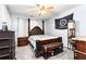 Bedroom featuring a poster bed with leather accents, a ceiling fan and gray walls at 1114 Ivey Chase Pl, Dacula, GA 30019