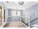 Upper hallway landing with white railings and light walls at 1114 Ivey Chase Pl, Dacula, GA 30019