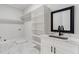 Bright laundry room with ample shelving and a utility sink at 1682 Union Grove Church Rd, Auburn, GA 30011