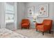 Main bedroom with two orange accent chairs and large windows at 20 Jacobs Farm Ln # 10, Lawrenceville, GA 30045