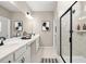 Bright bathroom showcasing double vanity, a large mirror, and a walk-in shower with black trim at 24 Jacobs Farm Ln # 12, Loganville, GA 30045