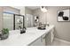 Bright bathroom featuring a double sink vanity, a large mirror and a walk-in shower with black trim at 24 Jacobs Farm Ln # 12, Lawrenceville, GA 30045