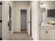 Hallway leading to a walk-in closet and a bright bathroom, showcasing seamless transitions and smart storage solutions at 24 Jacobs Farm Ln # 12, Lawrenceville, GA 30045