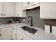 Modern kitchen sink and faucet with gray tile backsplash and white cabinets at 24 Jacobs Farm Ln # 12, Lawrenceville, GA 30045