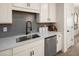 Modern kitchen sink and faucet with gray tile backsplash and white cabinets at 24 Jacobs Farm Ln # 12, Lawrenceville, GA 30045