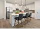 White kitchen island with quartz countertops and black leather barstools at 24 Jacobs Farm Ln # 12, Lawrenceville, GA 30045