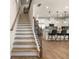 Elegant staircase with dark wood railing; overlooks kitchen at 24 Jacobs Farm Ln # 12, Loganville, GA 30045