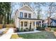 Charming two-story home with inviting front porch, manicured lawn, and private driveway on a sunny day at 2715 Memorial Se Dr, Atlanta, GA 30317